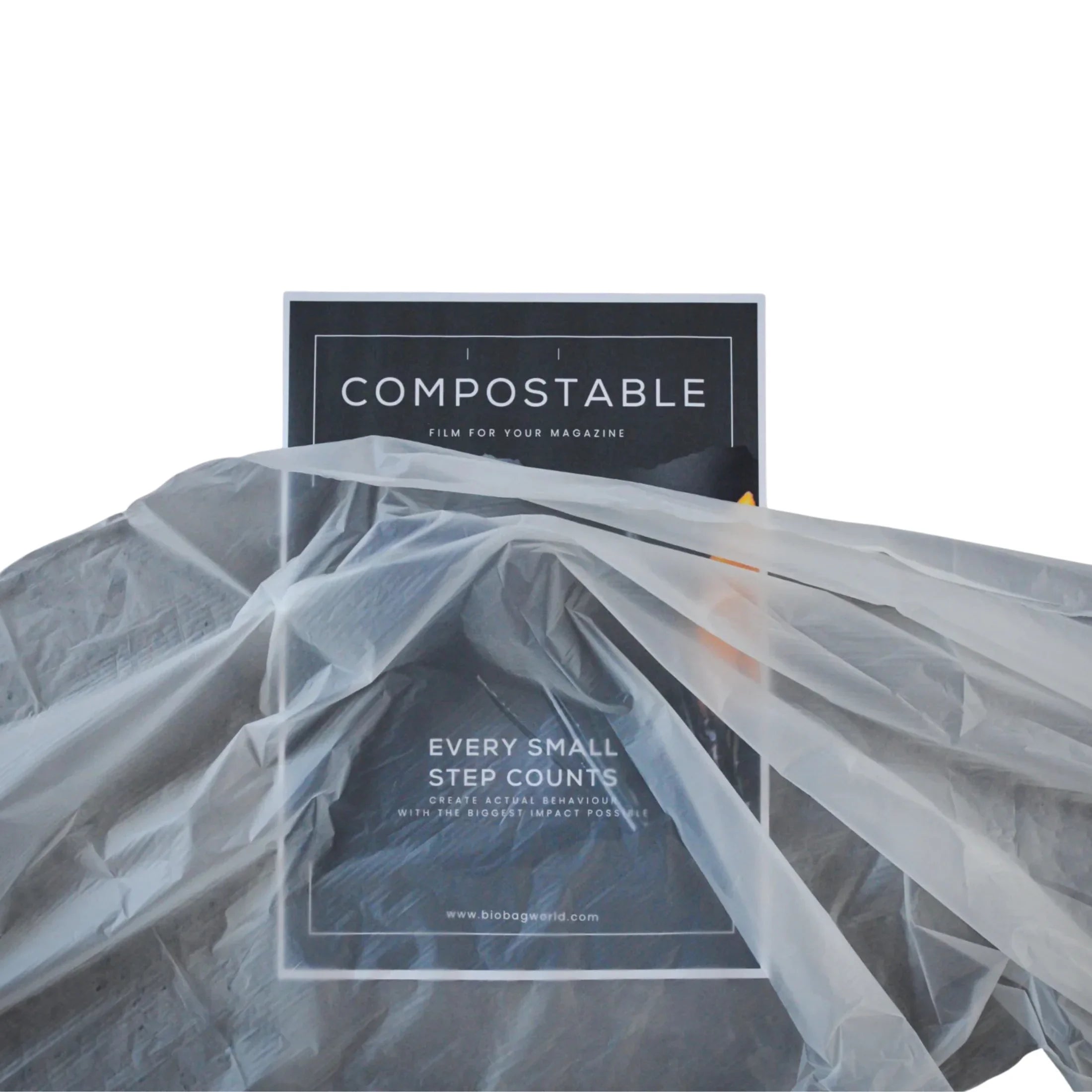 Compostable magazine film partially covered by transparent biodegradable plastic bag
